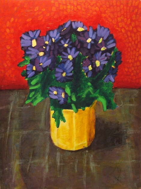 purple daisies in a yellow pot